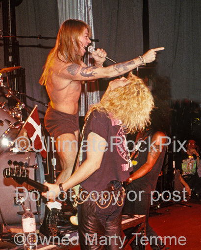 Photo of Axl Rose and Duff McKagan of Guns N' Roses in concert in 1990 by Marty Temme