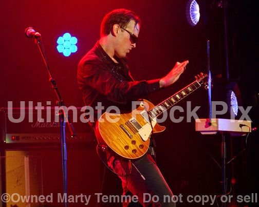 Photo of Joe Bonamassa playing a Les Paul and a theremin in concert by Marty Temme