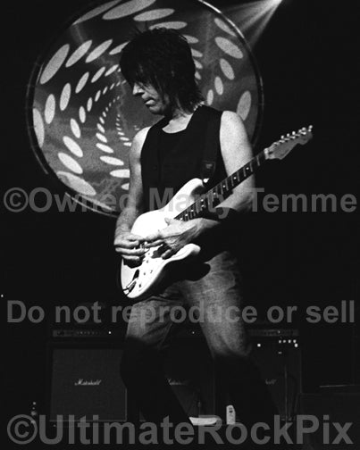 Black and white photo of Jeff Beck playing a Fender Stratocaster in concert by Marty Temme