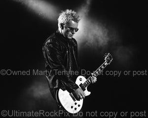 Black and white photo of Billy Duffy playing his Les Paul in concert by Marty Temme