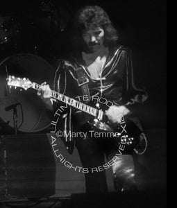 Photo of Tony Iommi of Black Sabbath in concert in 1976 by Marty Temme