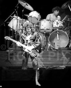 Photo of Tony Iommi and Bill Ward of Black Sabbath in concert in 1976 by Marty Temme