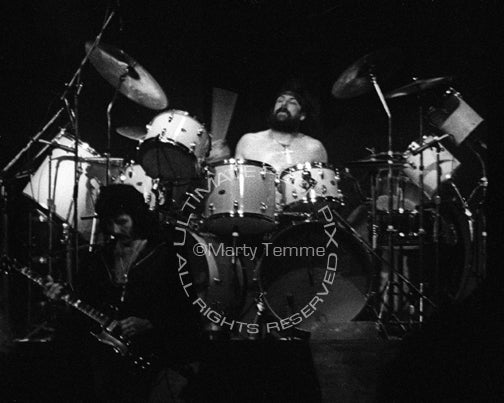 Photo of Bill Ward of Black Sabbath in concert in 1976 by Marty Temme