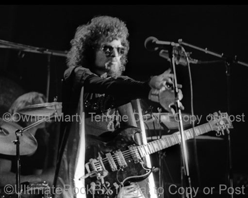 Photo of Eric Bloom of Blue Oyster Cult in concert in 1974 by Marty Temme