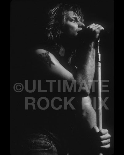 Black and white photo of Jon Bon Jovi onstage in 1992 by Marty Temme