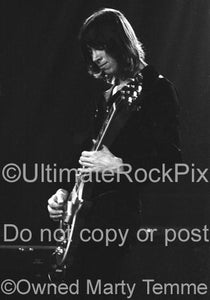 Black and white photo of Tom Scholz of Boston playing a Les Paul in concert in 1979 by Marty Temme