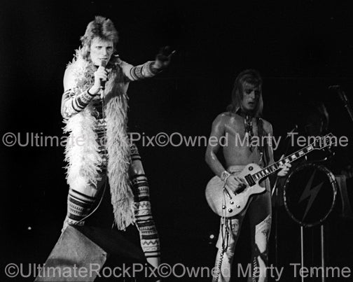 Photo of David Bowie and Mick Ronson onstage in 1973 by Marty Temme