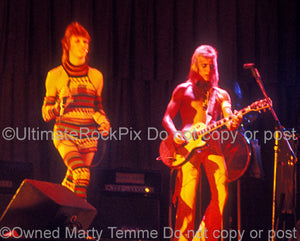 Photo of David Bowie and Mick Ronson in concert in 1973 by Marty Temme