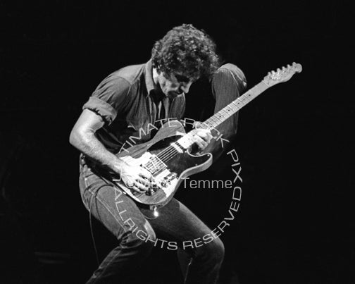 Black and white photo of Bruce Springsteen playing his Fender Telecaster in concert in 1978 by Marty Temme