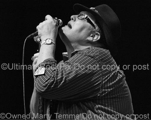 Black and white photo of John Popper of Blues Traveler in concert
