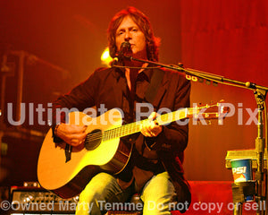 Photo of Brett Tuggle of Fleetwood Mac playing acoustic guitar in concert in 2007 by Marty Temme