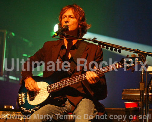 Photo of Brett Tuggle of Fleetwood Mac playing bass in concert in 2007 by Marty Temme