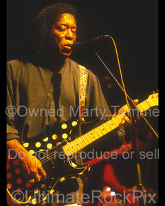 Photo of guitarist Buddy Guy playing a Fender Stratocaster in concert by Marty Temme