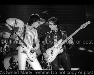 Photo of Elliott Easton and Benjamin Orr of The Cars in concert in 1978 by Marty Temme