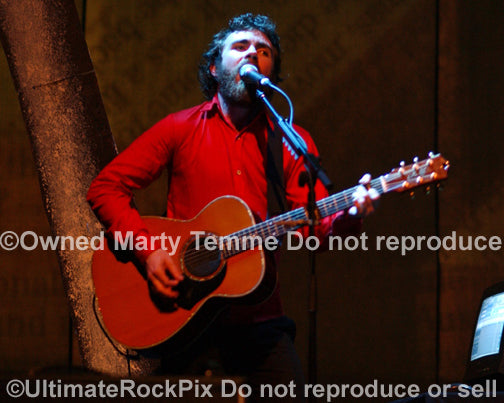 Photo of Liam Finn of Crowded House playing acoustic guitar in concert in 2007 by Marty Temme