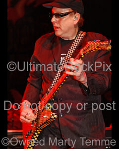 Photo of Rick Nielsen of Cheap Trick playing a Hamer guitar in concert in 2006 by Marty Temme