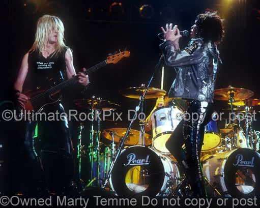 Photo of Tom Keifer and Eric Brittingham of Cinderella in concert in 1989 by Marty Temme