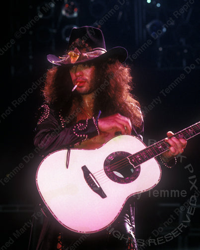 Photo of Jeff LaBar of Cinderella playing acoustic guitar in concert in 1989 by Marty Temme