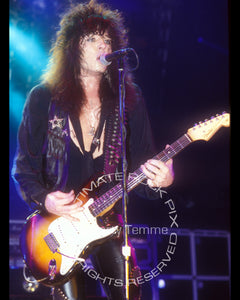 Photo of Tom Keifer of Cinderella playing a Stratocaster in concert in 1989 by Marty Temme