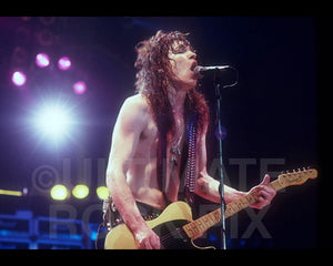 Photo of Tom Keifer of Cinderella playing a Telecaster in concert in 1989 by Marty Temme