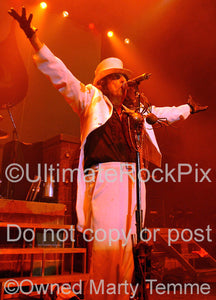 Photo of Alice Cooper in a white suit and top hat in concert in 2006 by Marty Temme