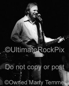 Photo of Stephen Stills of CSNY playing a Gibson Firebird in concert in 1977 by Marty Temme