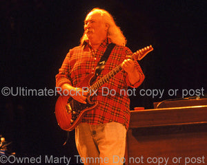 Photo of David Crosby of CSNY playing guitar in concert by Marty Temme