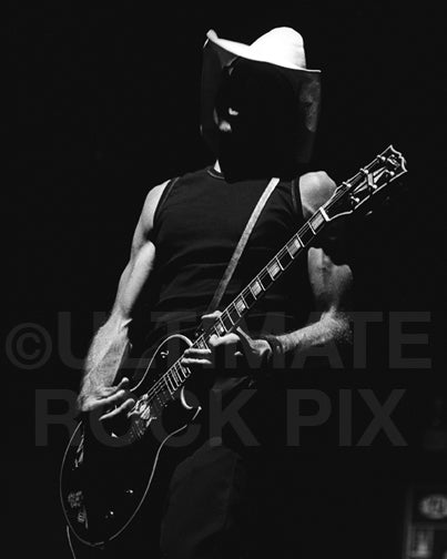 Photo of guitarist Mike Dimkich of The Cult playing a Les Paul in concert by Marty Temme
