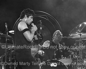 Photo of Ian Astbury and Matt Sorum of The Cult singing together in concert by Marty Temme