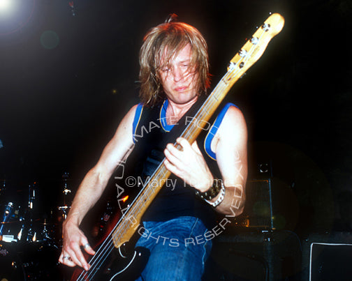 Photo of bass player Chris Wyse of The Cult in concert by Marty Temme