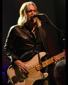Photo of bassist Chris Wyse of The Cult in concert by Marty Temme