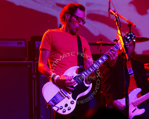Photo of guitar player Mike Dimkich of The Cult and Bad Religion playing a Gibson SG in concert