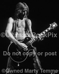Black and white photo of guitarist Doug Aldrich playing a Les Paul in concert by Marty Temme