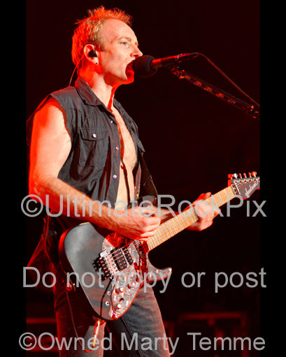 Photo of guitarist Phil Collen of Def Leppard in concert in 2006 by Marty Temme