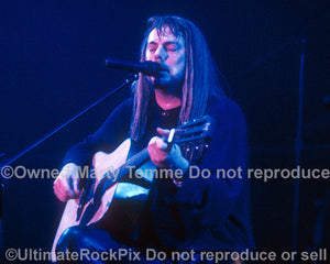 Photo of Don Dokken playing acoustic guitar in concert in 1995 by Marty Temme
