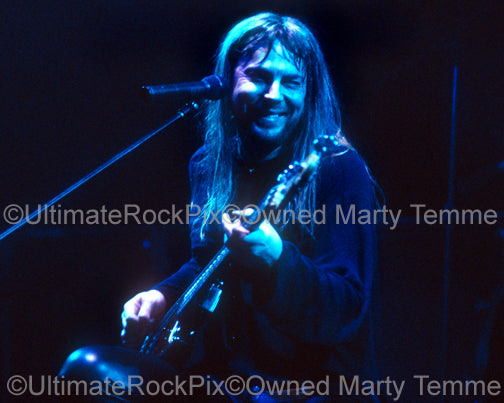 Photo of Don Dokken singing and playing bass in concert in 1995 by Marty Temme