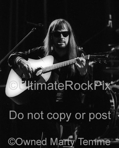 Black and white photo of Don Dokken playing guitar in concert in 1995 by Marty Temme