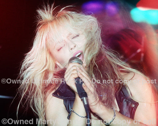 Photo of singer Doro Pesch in concert in 1990 by Marty Temme