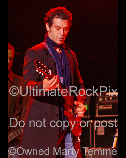 Photo of guitarist Doyle Bramhall II playing a Les Paul Junior in concert by Marty Temme