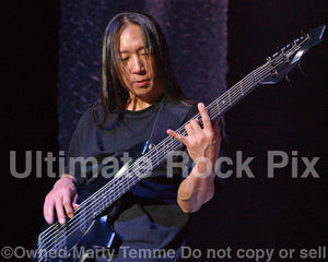 Photo of bassist John Myung of Dream Theater in concert in 2009 by Marty Temme