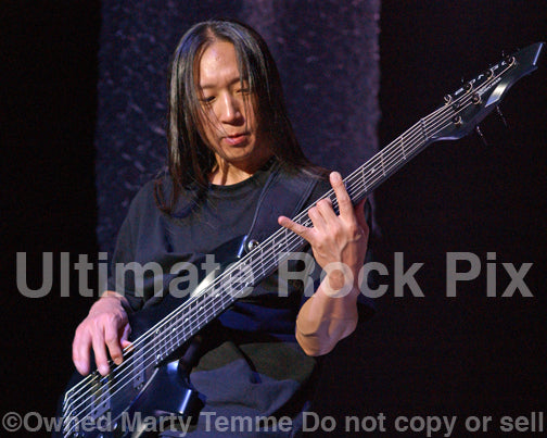Photo of bassist John Myung of Dream Theater in concert in 2009 by Marty Temme
