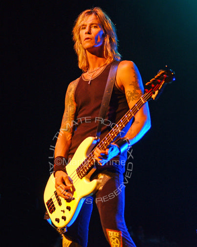 Photo of bass player Duff McKagan of Guns N' Roses in concert by Marty Temme