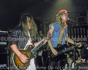 Photo of West Arkeen and Duff McKagan in concert in 1990 by Marty Temme