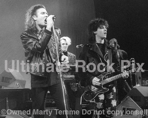 Photo of Simon Le Bon and Warren Cuccurullo of Duran Duran in concert in 1989 by Marty Temme