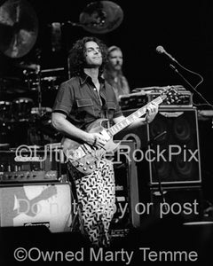 Photo of Dweezil Zappa playing a Gibson SG in concert in 2006 by Marty Temme