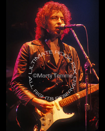 Photo of Bob Dylan playing a Fender Stratocaster in concert in 1980 by Marty Temme