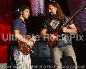 Photo of guitar players Dweezil Zappa and John Petrucci in concert in 2009 by Marty Temme