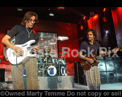 Photo of guitar players Dweezil Zappa and Steve Vai in concert in 2009 by Marty Temme