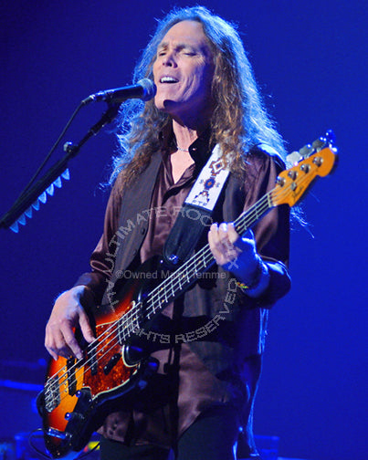 Photo of singer and bass player Timothy B. Schmit of The Eagles in concert by Marty Temme
