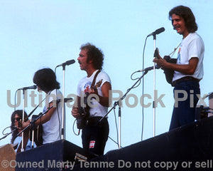 Photo of Randy Meisner, Glenn Frey, Bernie Leadon and Don Felder of The Eagles in concert in 1974 by Marty Temme